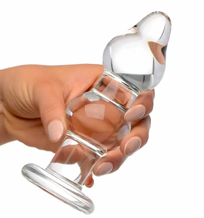 a hand holding the double glass anal plug with a flared base and bulbous head