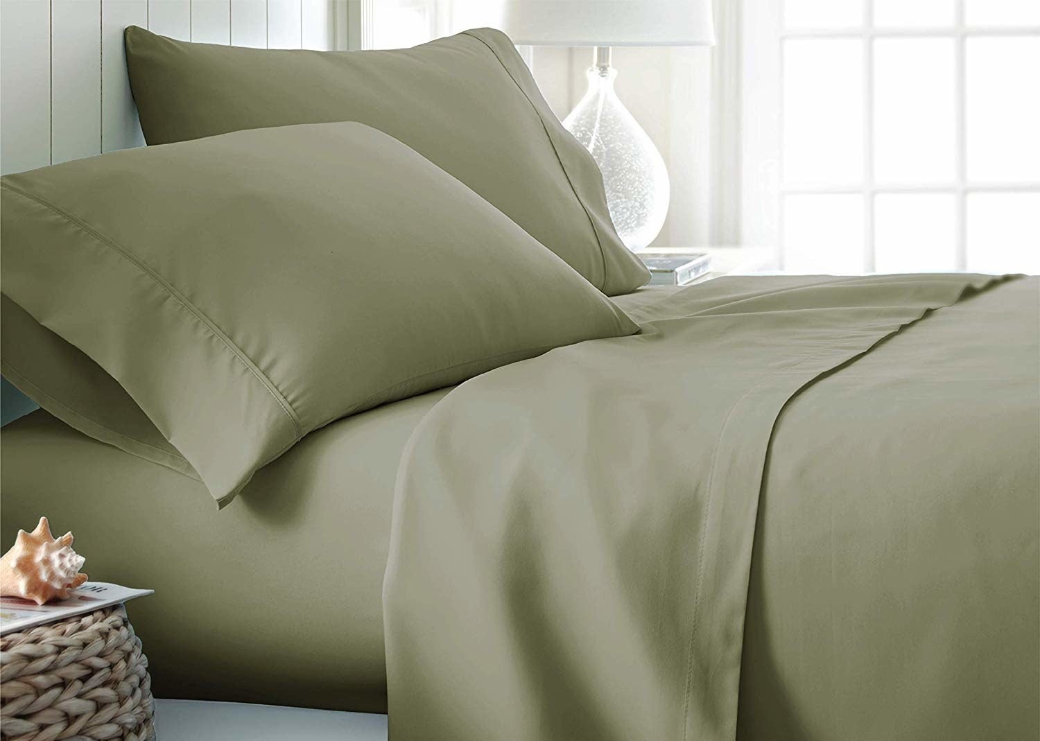 the sheets in olive green on a bed 