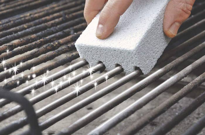A sponge-like cleaner picking up grime on a dirty grill