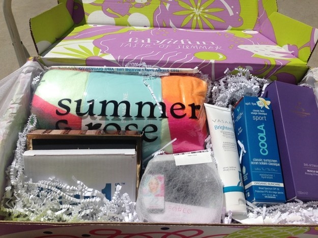 fab fit fun box filled with a towel, sunscreen, a facial scrubber, and other obscured goodies