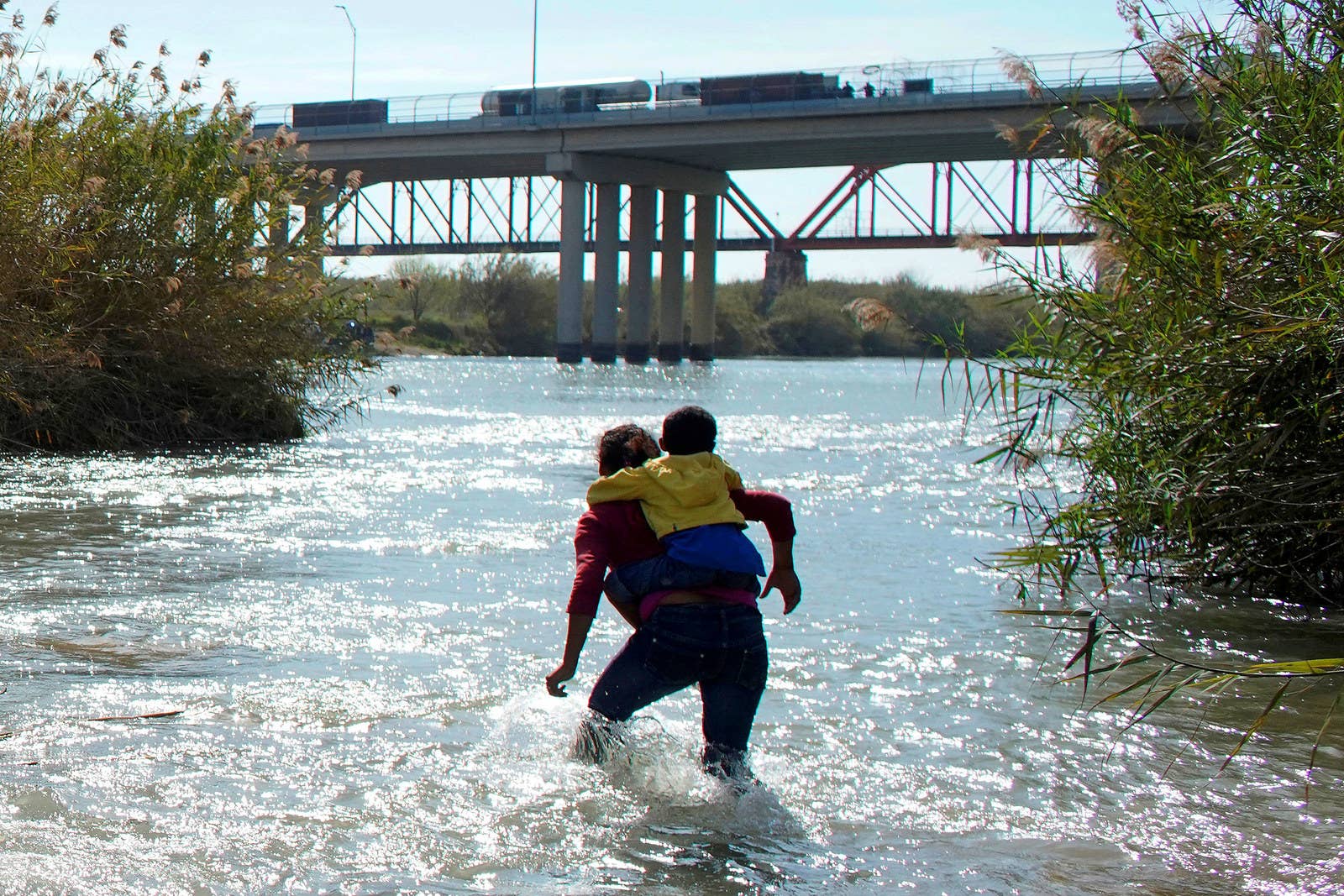 Honduran migrants cross the Rio Grande toward the United States on Feb. 16.