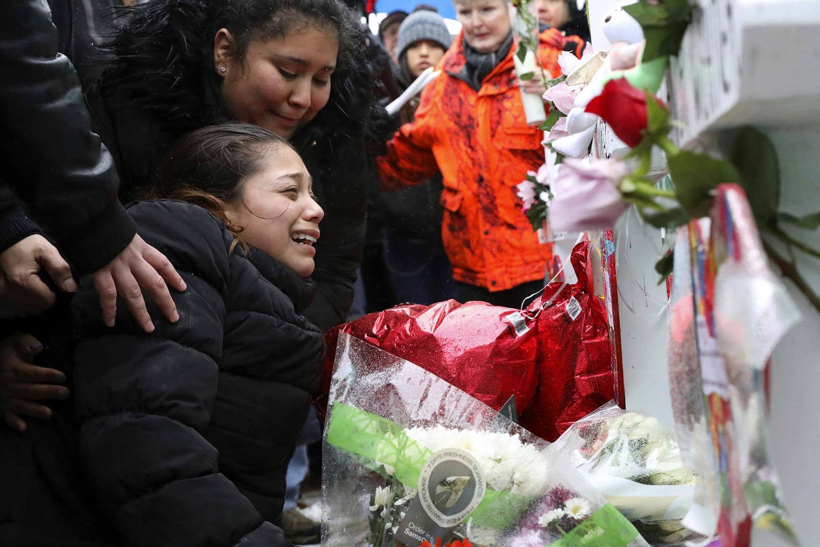 Vicente Juarez&#x27;s daughter, Diana Juarez, cries at a makeshift memorial on Feb. 17, in Aurora, Illinois, near the Henry Pratt manufacturing company facility, where her father and several others were killed last Friday by a gunman.