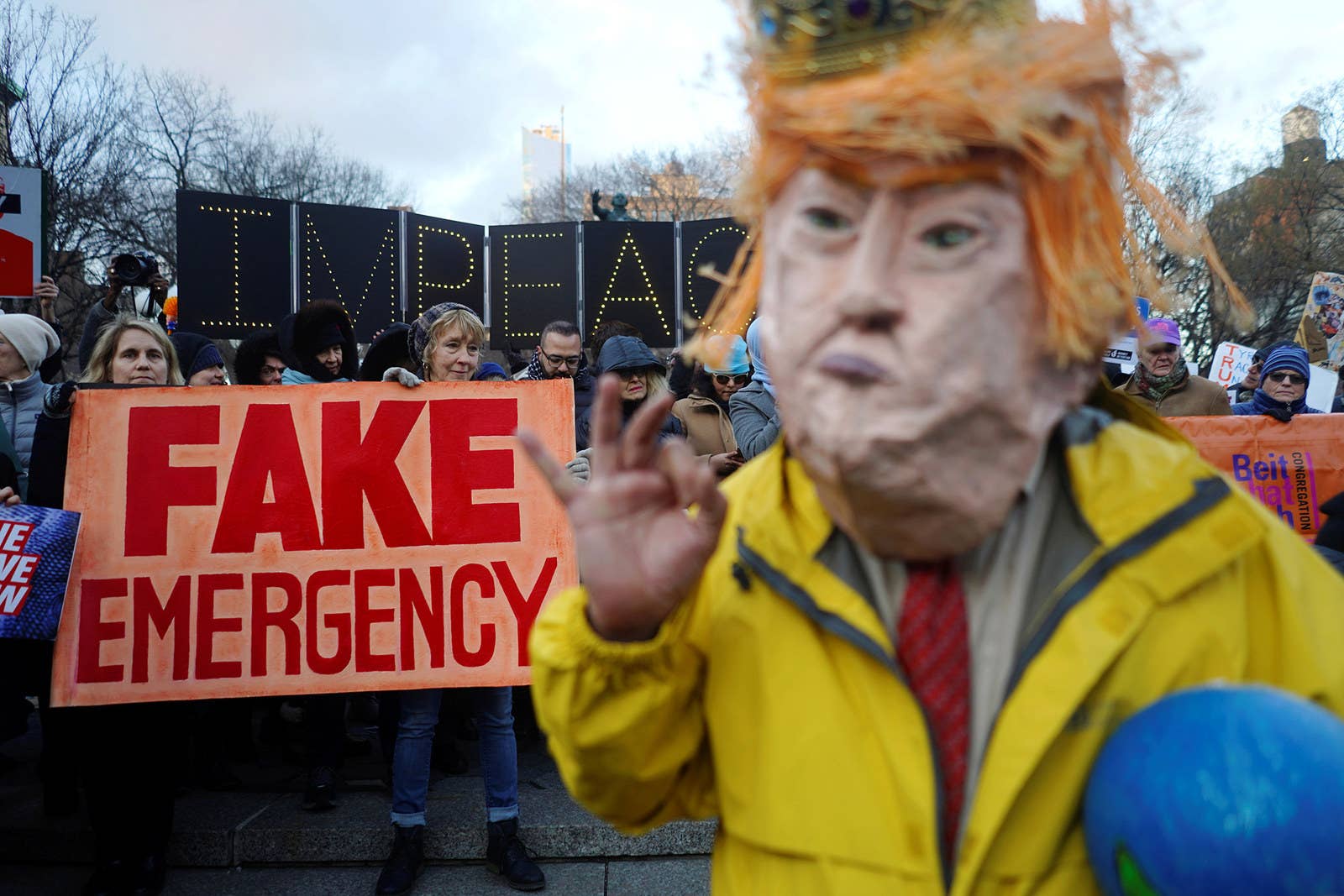 Protesters hold signs during a demonstration against President Donald Trump in New York City on Presidents Day, Feb. 18.