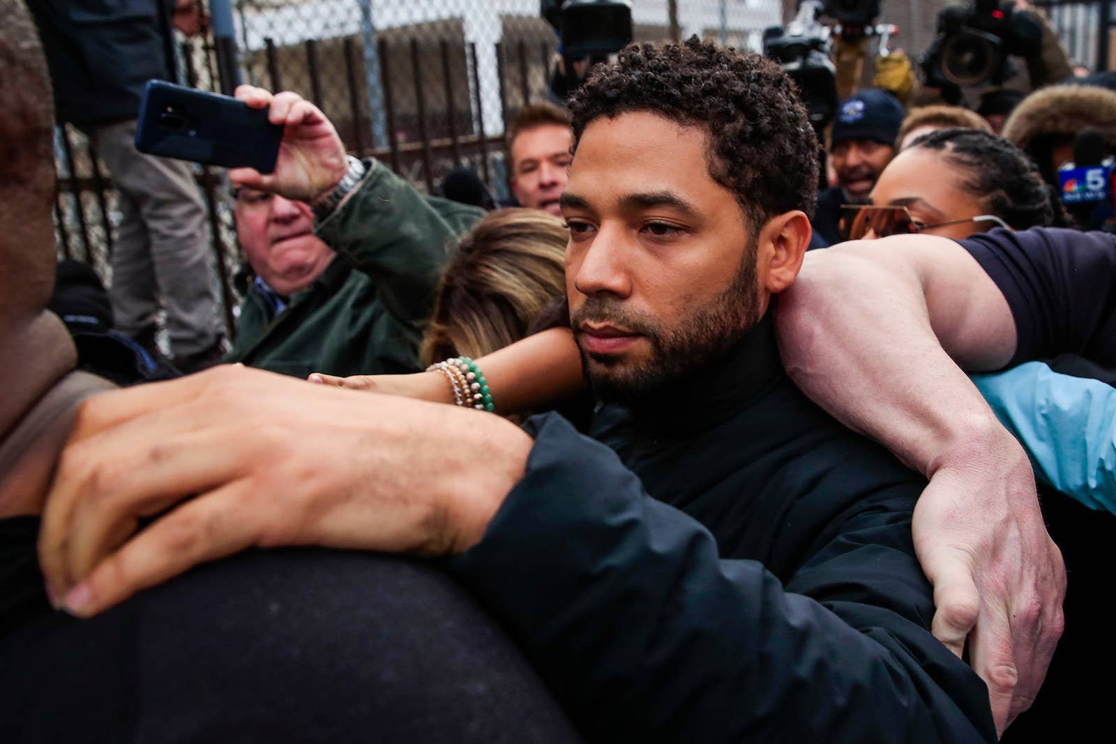 Empire actor Jussie Smollett emerges from the Cook County Court complex after posting 10% of a $100,000 bond in Chicago, on Feb. 21, 2019. Smollett was charged with felony disorderly conduct for allegedly filing a false police report claiming he was attacked in an incident that has drawn national attention.