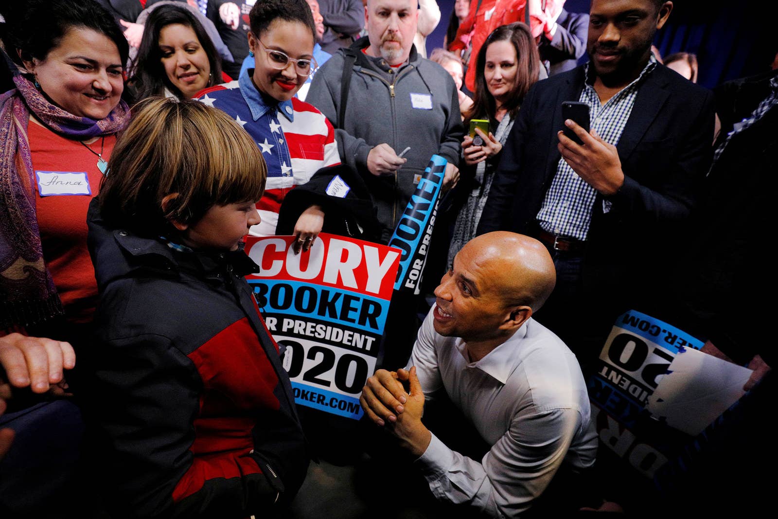 Sen. Cory Booker, a Democratic 2020 presidential candidate, talks to 9-year-old Alex Pringle during a campaign stop in Portsmouth, New Hampshire, on Feb. 16.