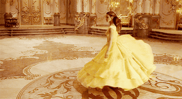 Actress twirling in yellow dress