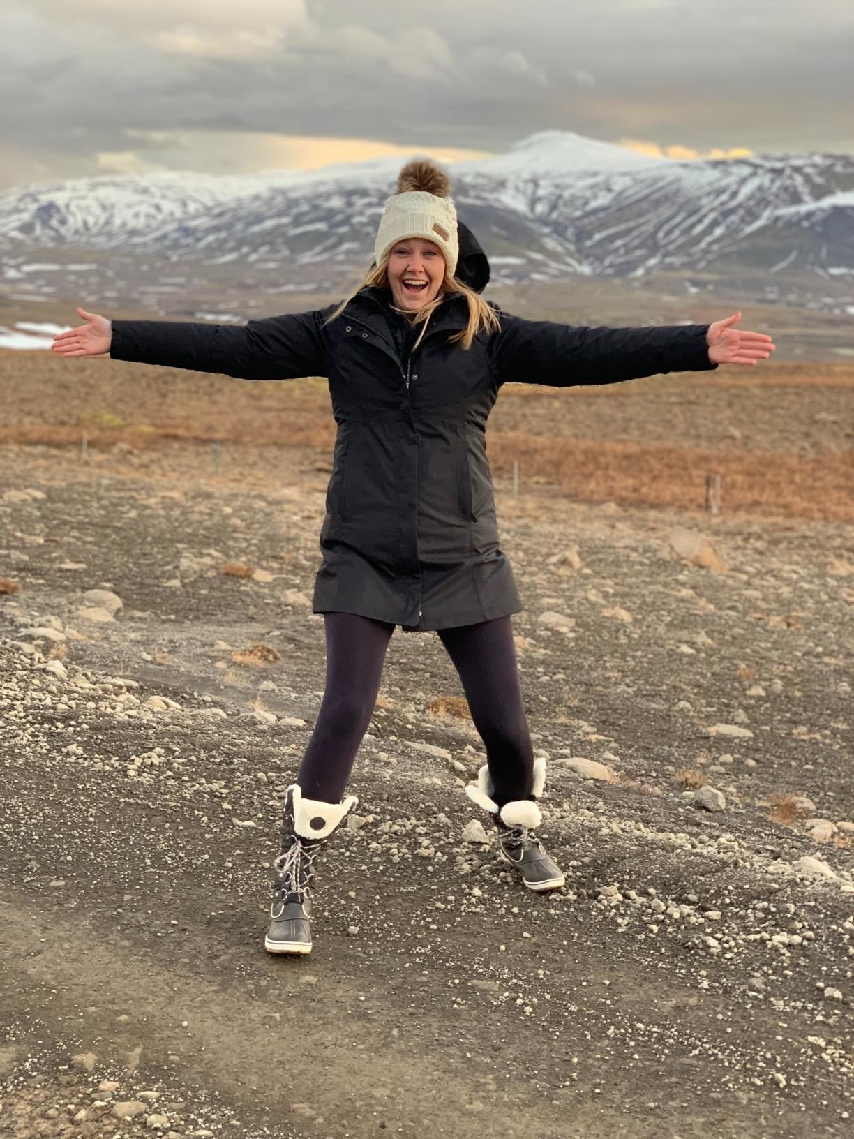 A reviewer wearing the leggings in a winter landscape