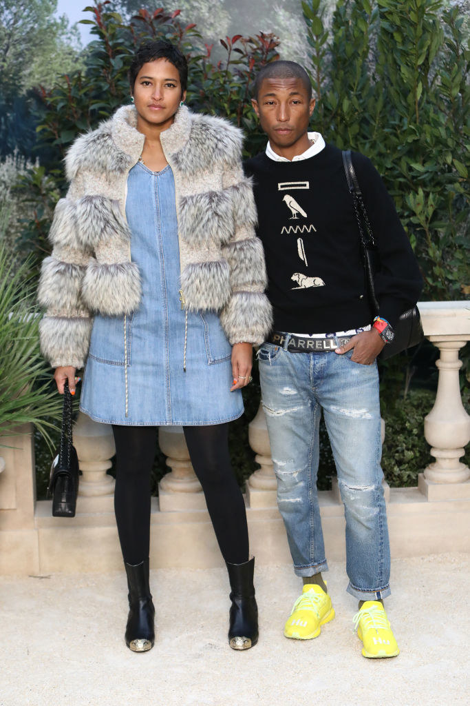 Pharrell Williams arrives at LAX in style. He wore a patchwork coat  complimented by a polka dot waistcoat with long tailed denim shirt. On his  feet he had snake skin slip-on sneakers