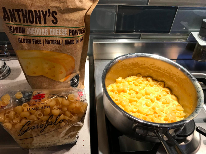 pot of gooey mac and cheese next to bag of powder