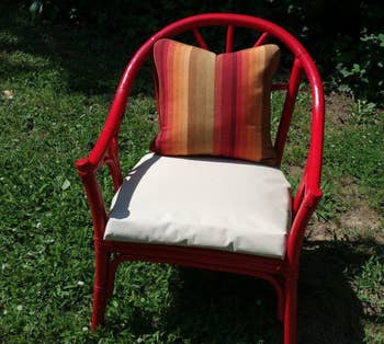 A reviewer showing the same chair looking new with a coat of red spray paint