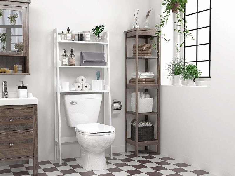 the white organizer with three shelves over a toilet in a bathroom