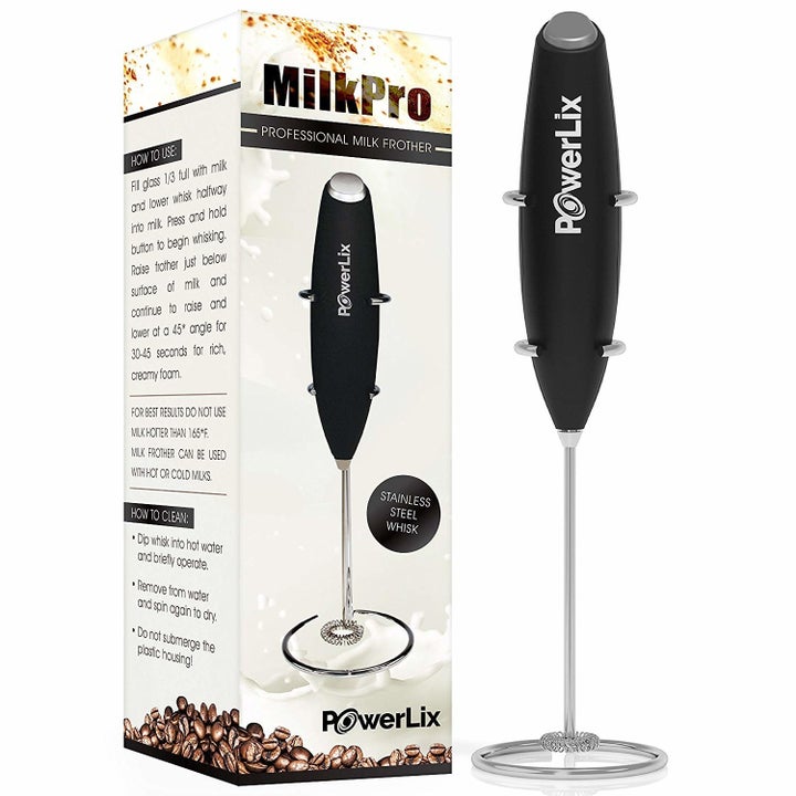 the handheld milk frother displayed next to its packaging