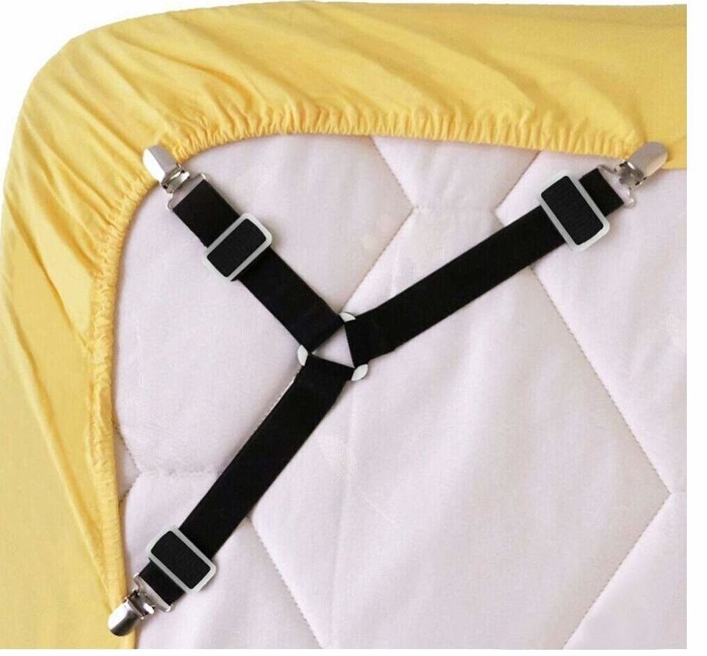 the elastic fasteners attached to a yellow fitted sheet over a white mattress