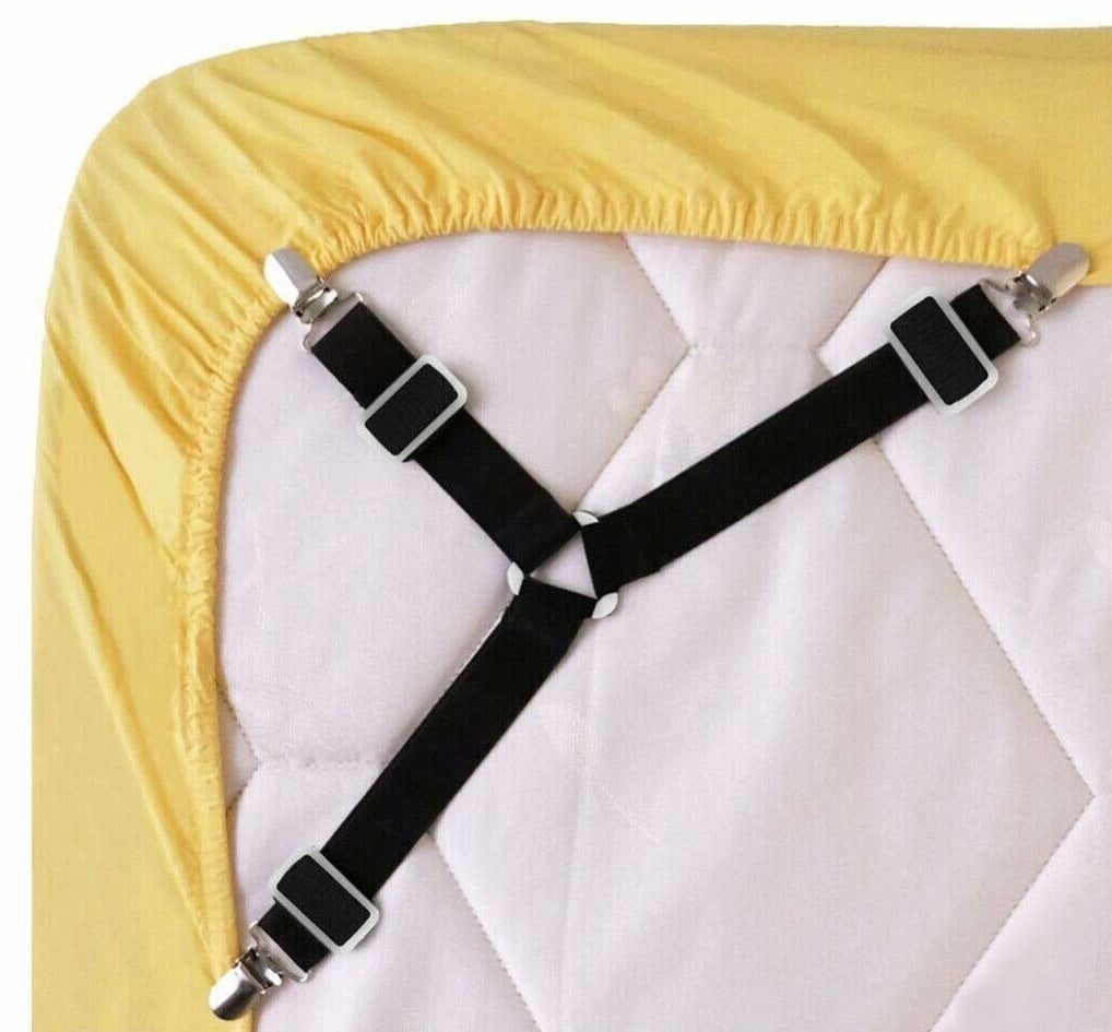 the elastic fasteners attached to a yellow fitted sheet over a white mattress