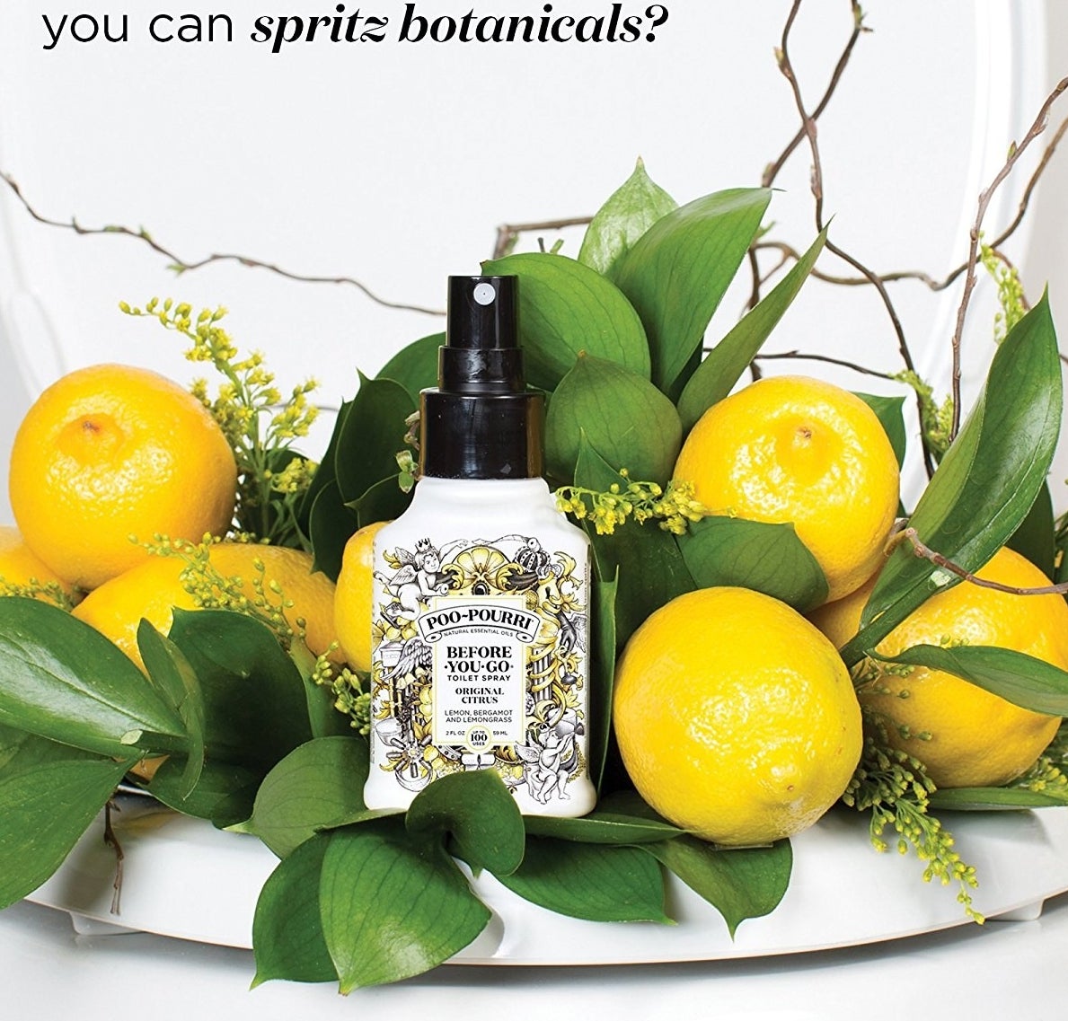 the bottle of poo-pourri displayed next to some lemons