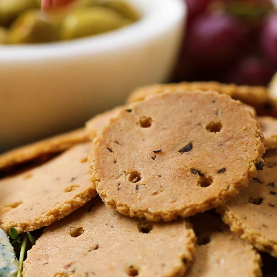 Servings: 4 INGREDIENTS2 cups almond flour1 teaspoon salt½ teaspoon pepper2 tablespoons minced fresh rosemary2 tablespoons olive oil3-5 tablespoons ice waterPREPARATION1.Preheat the oven to 350˚F (180˚C).2.In a large bowl, combine the almond flour, salt, pepper, and rosemary. 3.Add the olive oil and mix thoroughly with a fork. 4.Add the ice water, 1 tablespoon at a time, and mix thoroughly, until small clumps form and the dough holds together when squeezed. 5.Form the dough into a round, flattening the top and bottom as evenly as possible. 6.Place the dough on a sheet of parchment paper and add another piece of parchment on top. Roll out the dough as evenly as possible, to between ¼- and ⅛-inch thick.7.Remove the top layer of parchment paper and place on a baking sheet. You may need to press the edges of the dough to form an even rectangle.8.Using a cookie cutter or pizza cutter, slice the dough to desired size. If using a cookie cutter, re-roll the excess dough and cut out more crackers. If desired, use the blunt end of a skewer to poke holes in each of the crackers. 9.Carefully place the crackers on the baking sheet. If the dough is too warm, the crackers will break as you attempt to transfer them. Chill in the freezer for 10 minutes before proceeding if this happens.10.Bake for 15-20 minutes, flipping halfway, until golden brown.11.Let the crackers cool completely and serve as desired. Store up to 1 week at room temperature in an airtight container. 12.Enjoy!