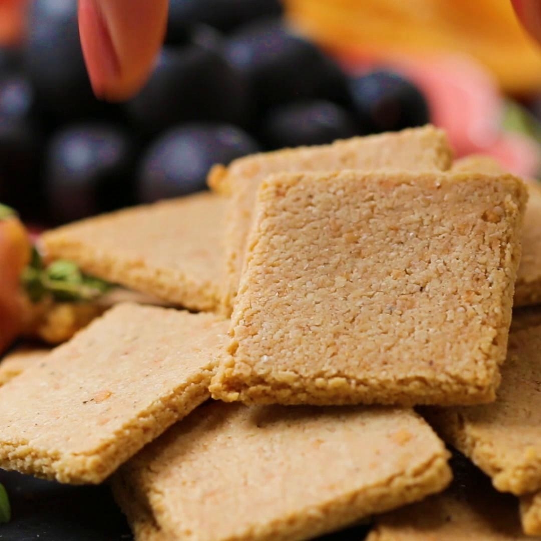 Servings: 4 INGREDIENTS2 cups almond flour1 teaspoon salt½ teaspoon pepper1 teaspoon garlic powder¼ cup grated Parmesan cheese2 tablespoons avocado oil or olive oil3-5 tablespoons ice waterPREPARATION1.Preheat the oven to 350˚F (180˚C).2.Combine the almond flour, salt, pepper, garlic powder, and Parmesan in a large bowl. 3.Add the avocado oil and mix thoroughly with a fork. 4.Add the ice water, 1 tablespoon at a time, and mix thoroughly, until small clumps form and the dough holds together when squeezed.5.Form the dough into a round, flattening the top and bottom as evenly as possible. 6.Place the dough on a sheet of parchment paper and add another piece of parchment on top. Roll out the dough as evenly as possible, to between ¼- and ⅛-inch thick.7.Remove the top layer of parchment paper and place on a baking sheet. You may need to press the edges of the dough to form an even rectangle.8.Using a cookie cutter or pizza cutter, slice the dough to desired size. If using a cookie cutter, re-roll the excess dough and cut out more crackers. If desired, use the blunt end of a skewer to poke holes in each of the crackers. 9.Carefully place the crackers on the baking sheet. If the dough is too warm, the crackers will break as you attempt to transfer them. Chill in the freezer for 10 minutes before proceeding if this happens.10.Bake for 15-20 minutes, flipping halfway, until golden brown. 11.Let the crackers cool completely and serve as desired. Store up to 1 week at room temperature in an airtight container. 12.Enjoy!