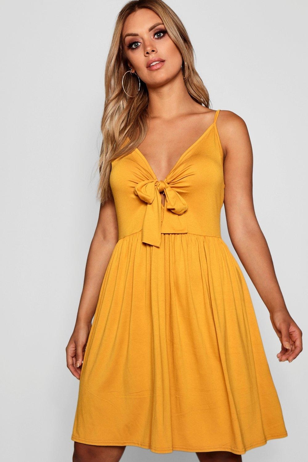 model wears yellow dress with bow front 