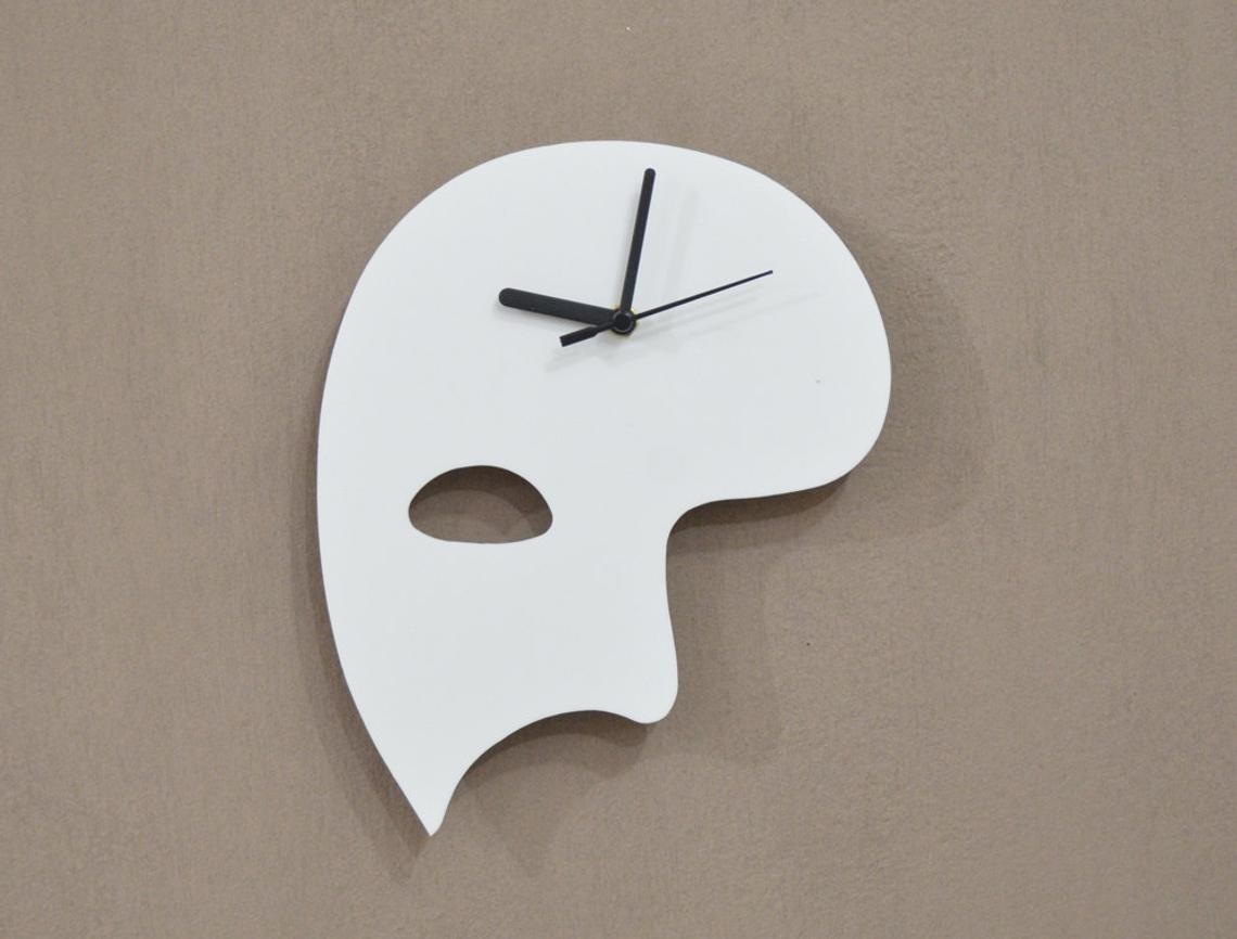 A white phantom half mask with black clock hands