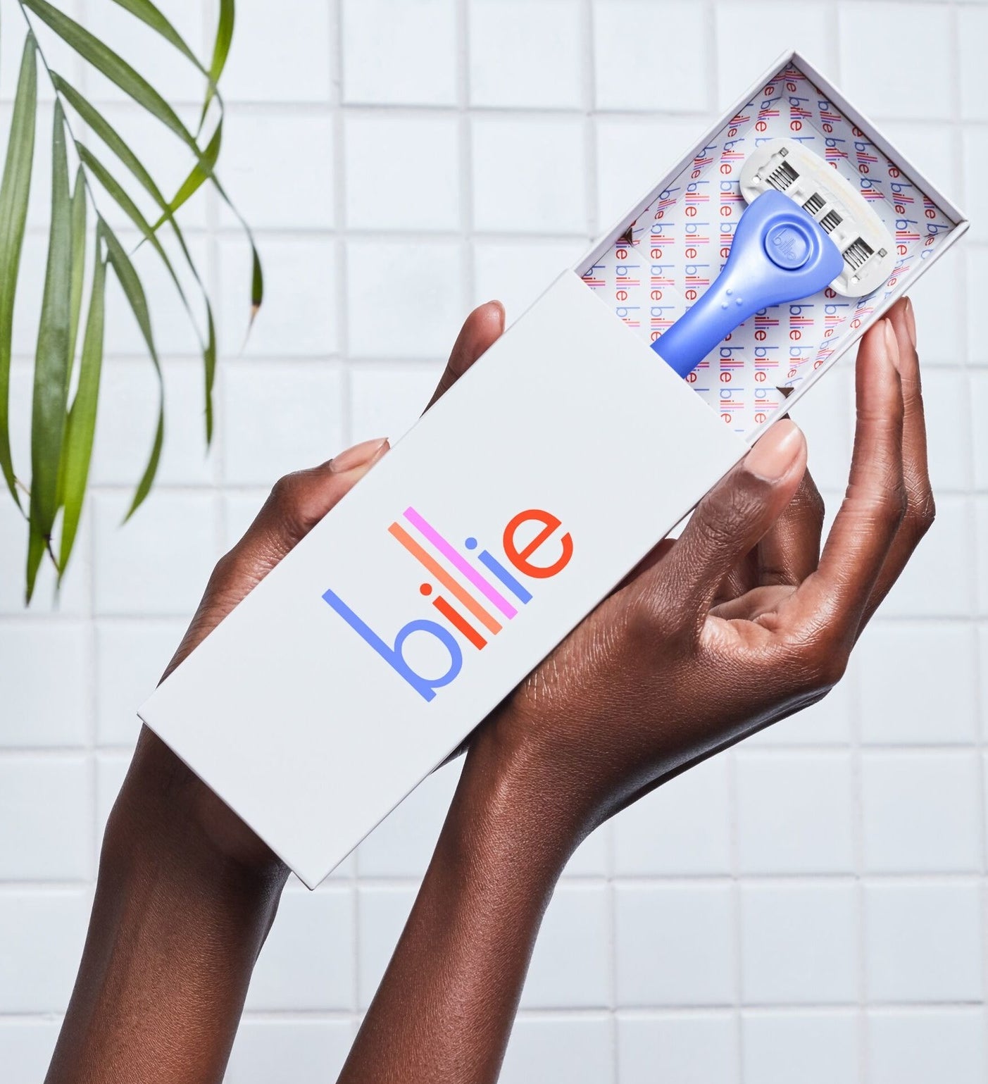 Hands holding a "Billie" box with a periwinkle razor peeking out
