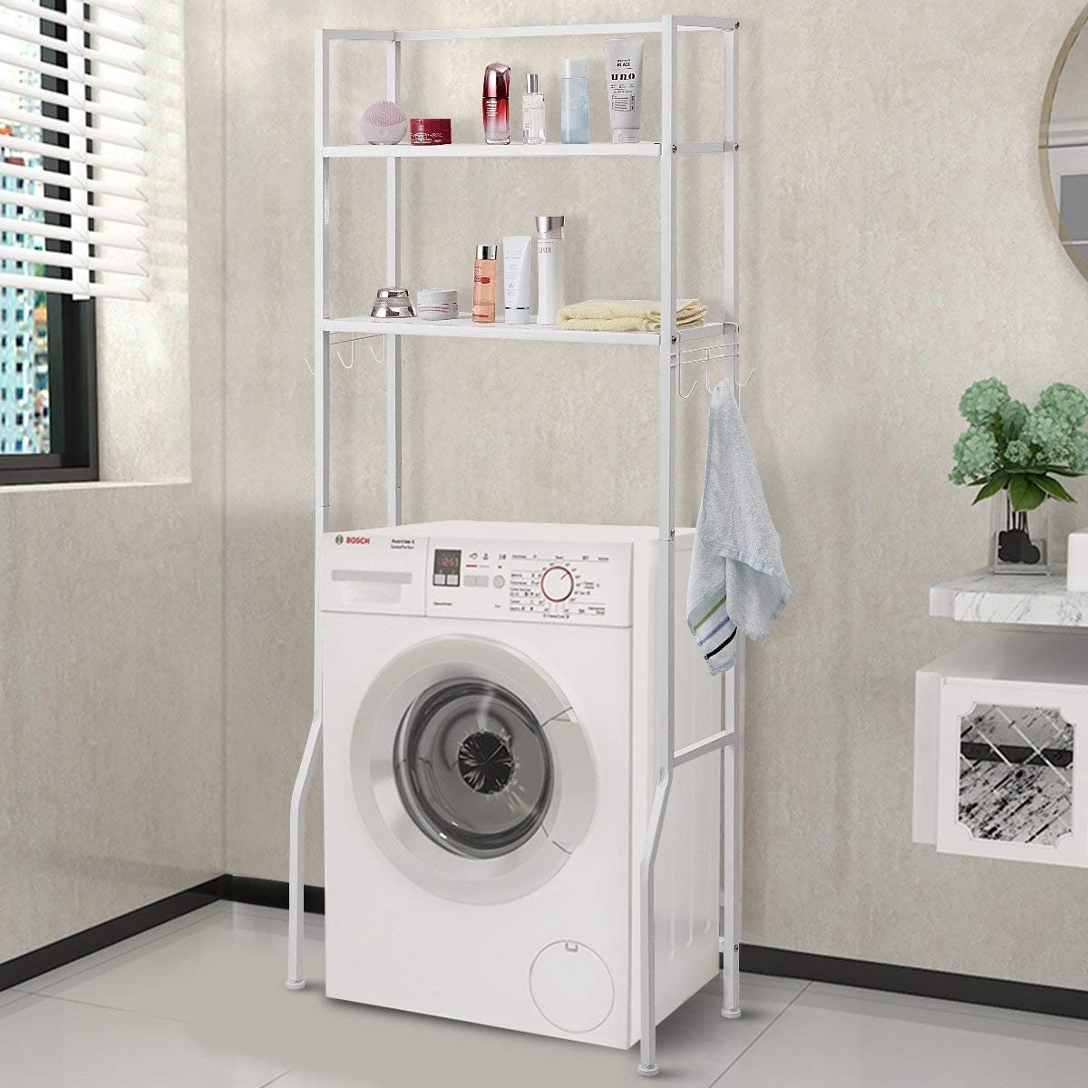 white metal rack over a washing machine with two shelves and three hooks on either side