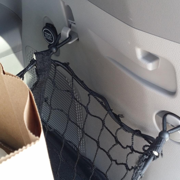Reviewer photo of a close-up of the mesh organizer hooking onto the car