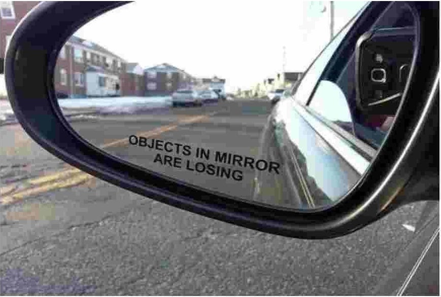 sticker on side mirror that says "objects in the mirror are losing"