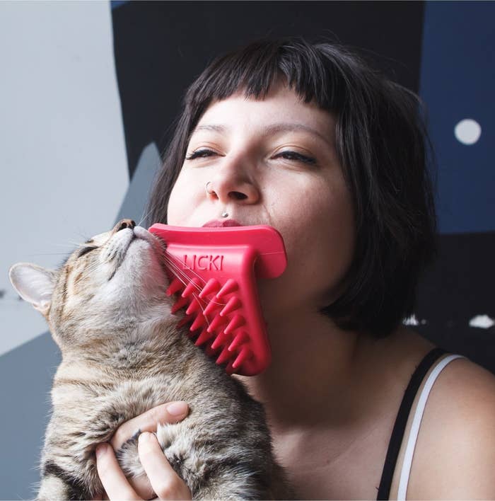 model licks cat with plastic pronged tongue 