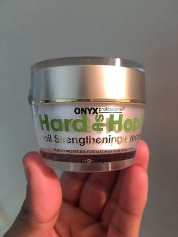 reviewer holding the palm-sized jar 