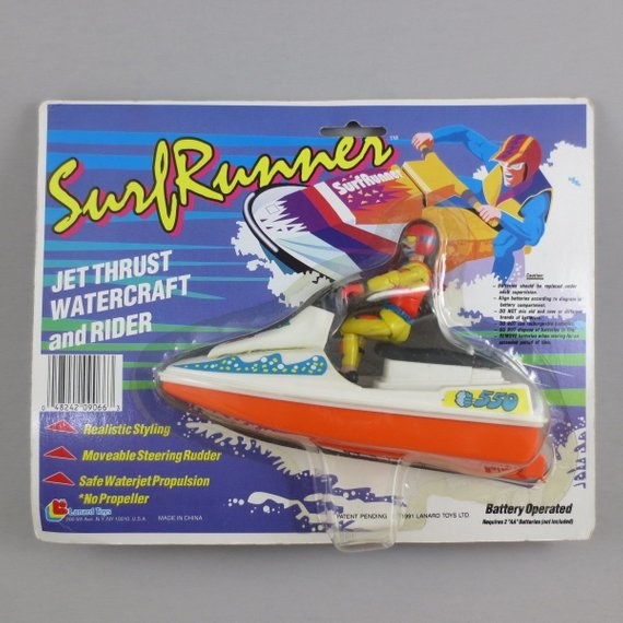 A orange and white jet ski toy in its package