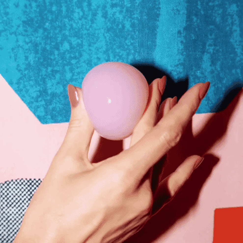 A gif of a model&#x27;s hand squeezing the jelly ball to show its soft texture