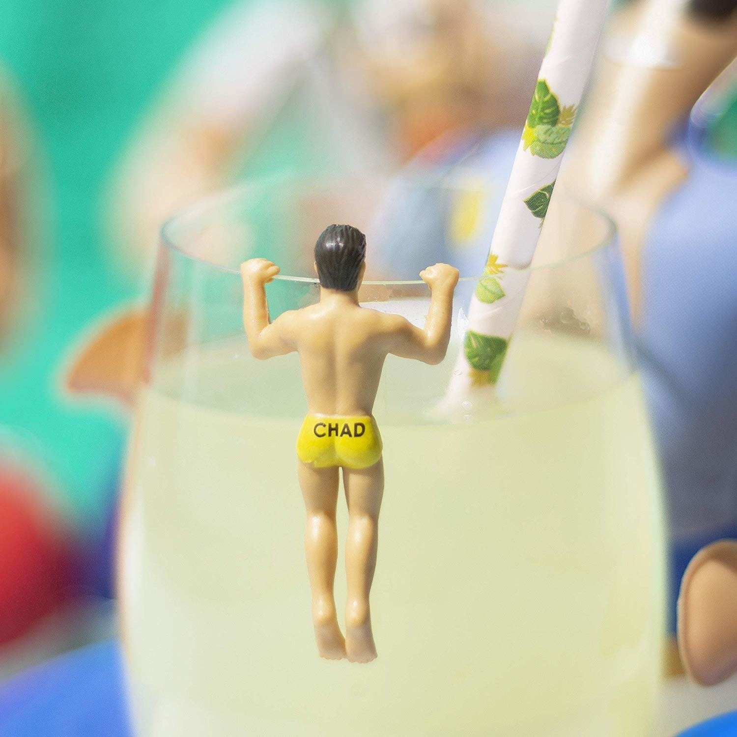 toy person with &quot;Chad&quot; on their swimsuit that hangs on the edge of a glass