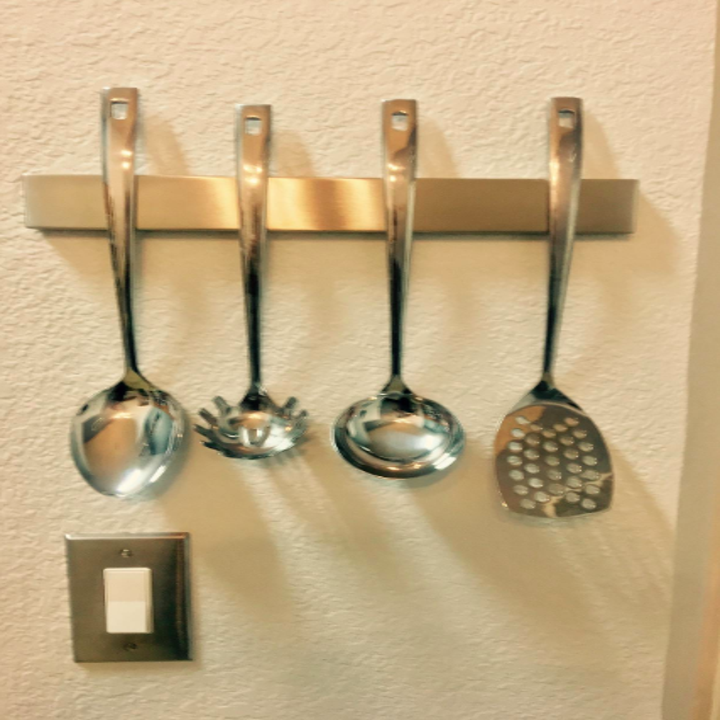 a different reviewer's photo of utensils hanging from the knife strip 