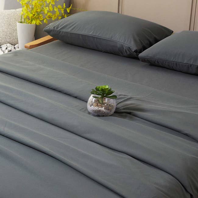 gray sheet set on bed
