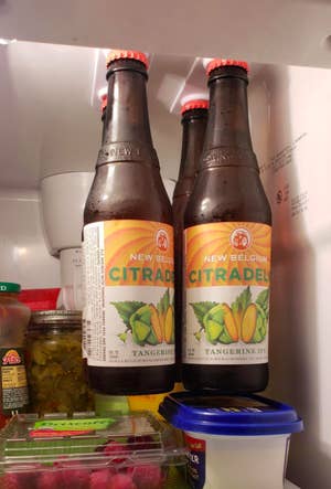A reviewer's photo of the holders elevating four beer bottles