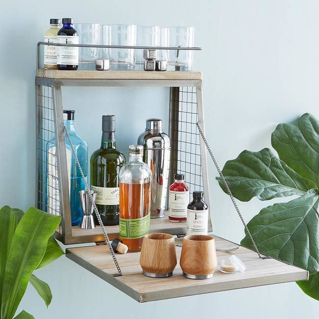 The foldout bar which has two storage shelves and a small table