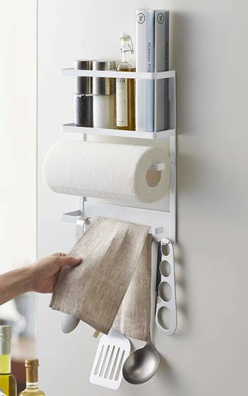 magnetic rack with different places for utensils, spices, towels, and paper towels