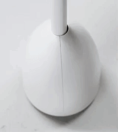 gif of hand lifting the white and blue rounded toilet brush out of its canister, showing how the canister opens automatically
