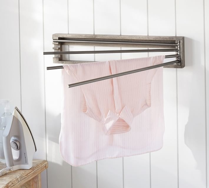 Wall mounted drying rack with shirt on it 