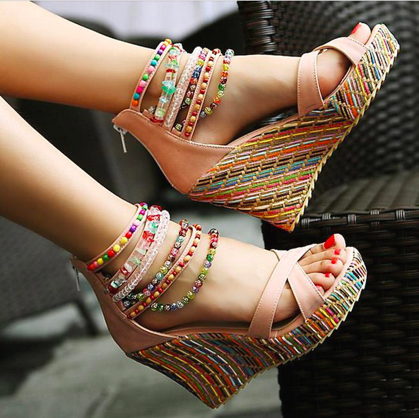 model wearing wedges with colorful wedges and beaded straps