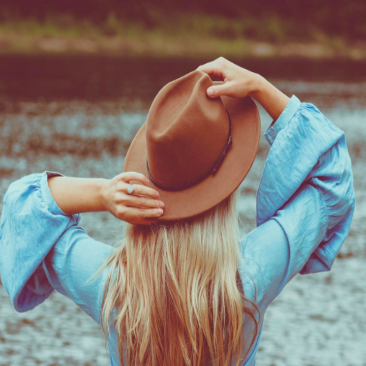 reviewer wears wide brimmed hat