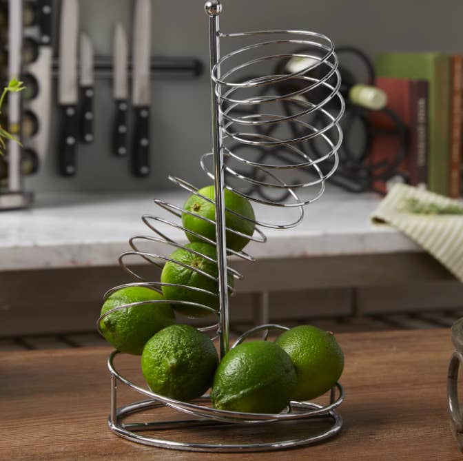 An upright spiral fruit basket in stainless steel 