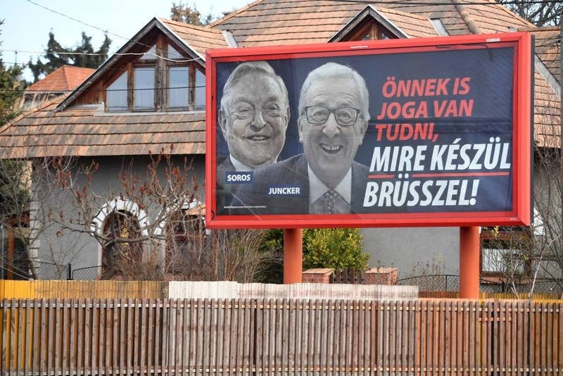 A billboard featuring pictures of European Commission president Jean-Claude Juncker and Hungarian-born US investor and philanthropist George Soros. The slogan translates to: &quot;You too have a right to know what Brussels is preparing.&quot;