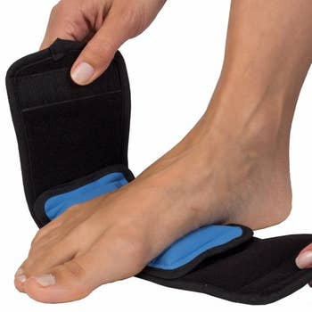 hands wrap foot into black and blue therapy wrap