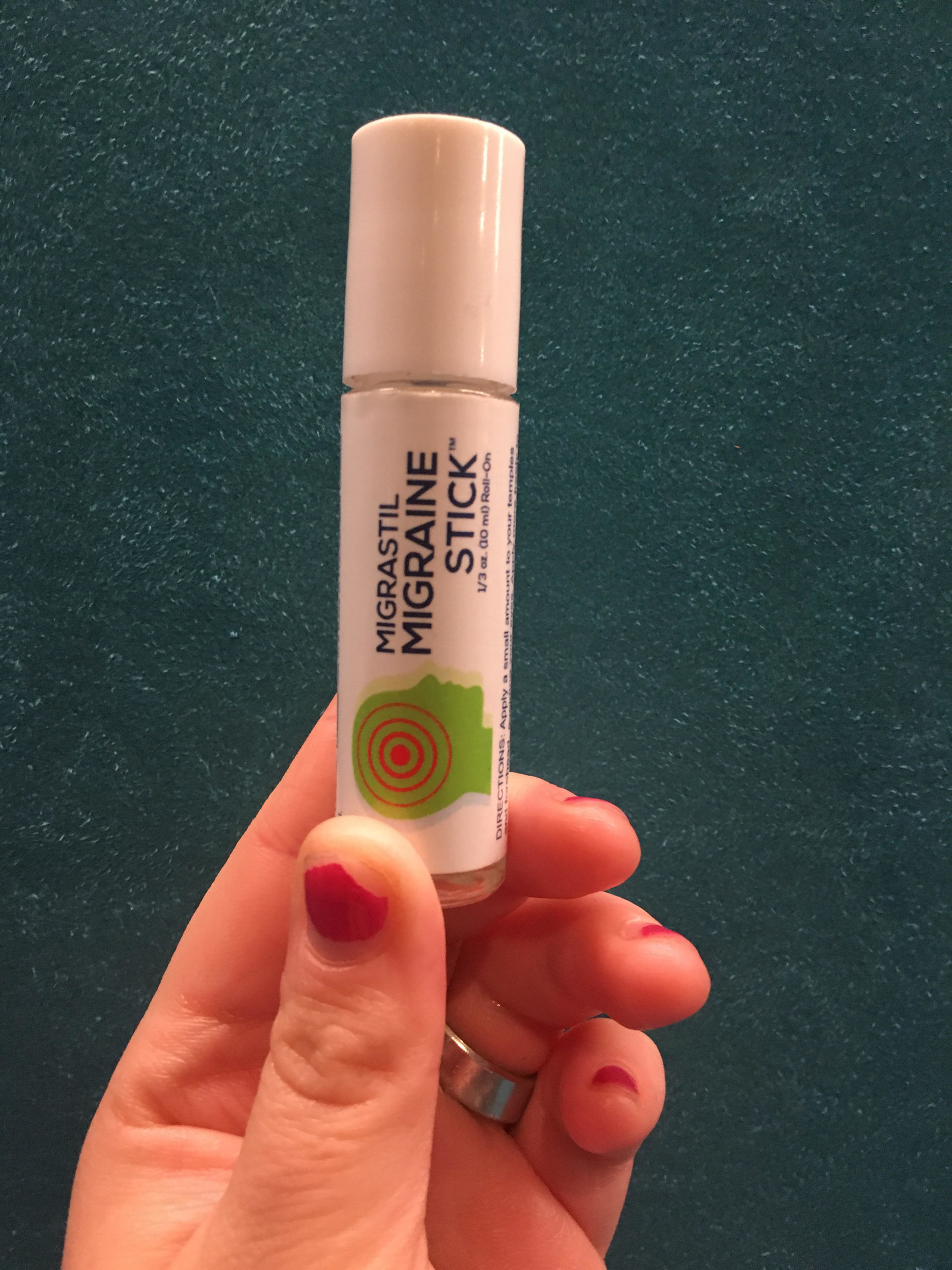 Writer holding the migraine stick