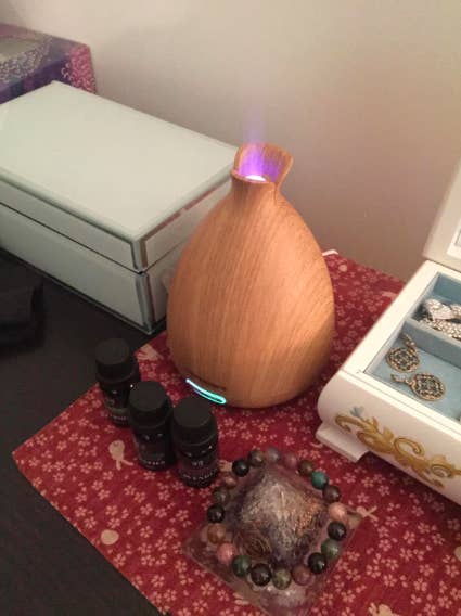 a reviewer&#x27;s photo of the diffuser lighting up while in-use