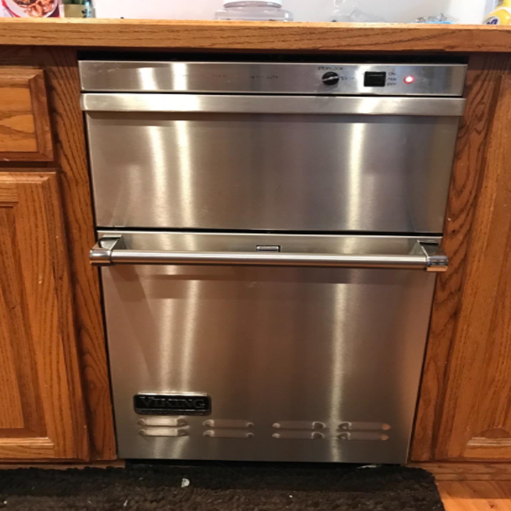 The same dishwasher without any fingerprints or smudges after using the stainless steel cleaner