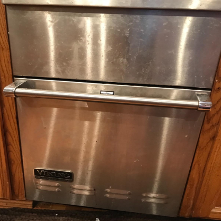 Reviewer photo of their stainless steel dishwasher covered in fingerprints