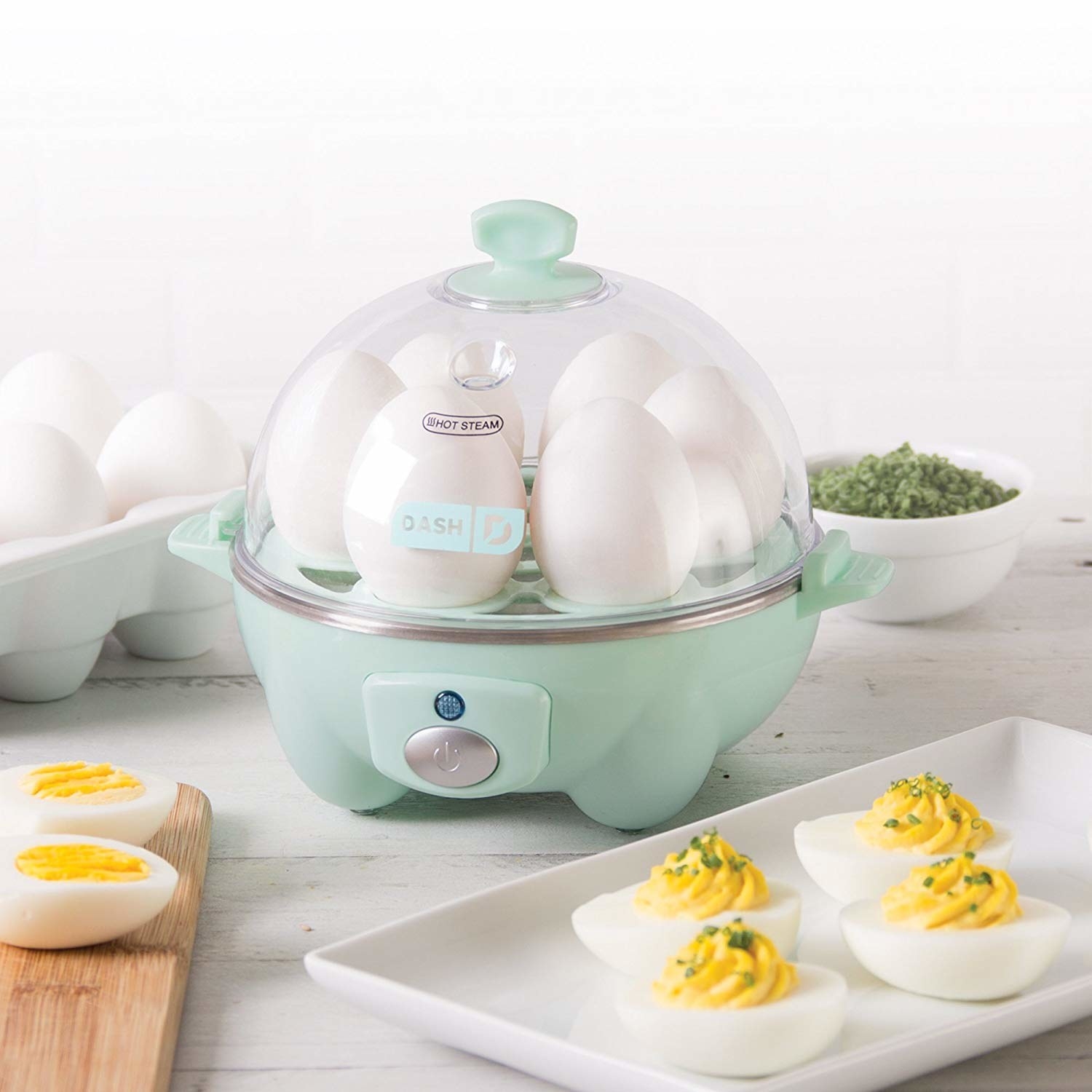 light blue domed egg cooker with six eggs inside