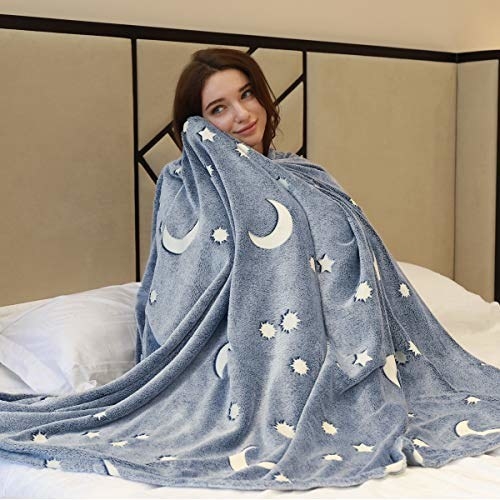 model cuddles with blue blanket with white stars and moons